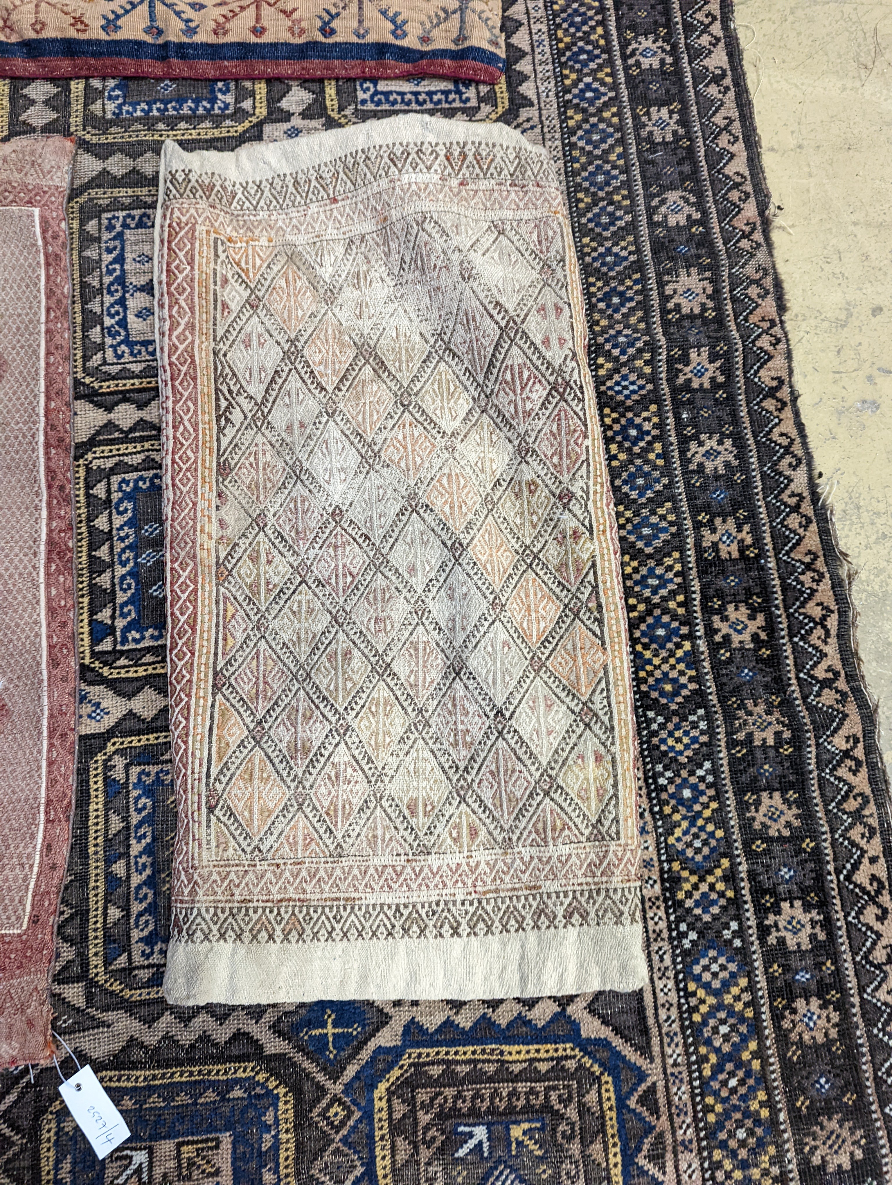 A Belouch geometric rug, 216 x 130cm. together with four Kelim cushion covers